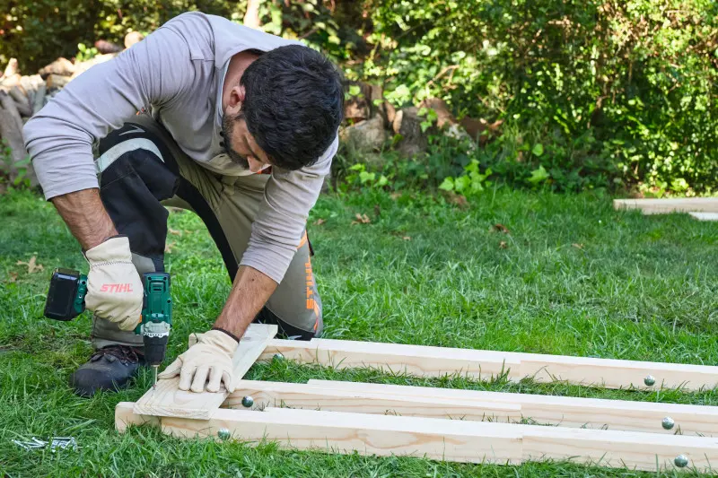 Krok 5. Przykręć pierwszą deskę do listew, dbając o jej prawidłowe wyrównanie.